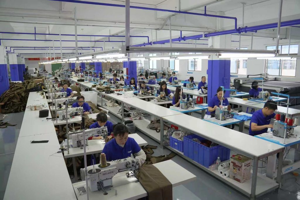 Workers operating industrial sewing machines in the Gahumi workshop
