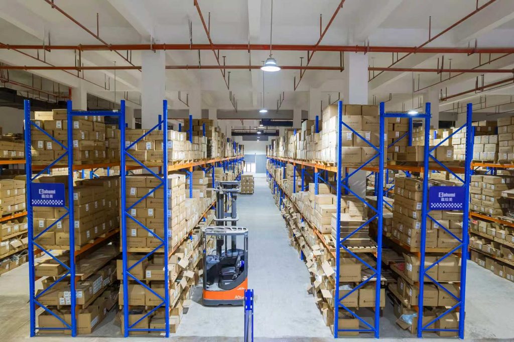 Cartons stored on blue and orange racks in the Gahumi warehouse